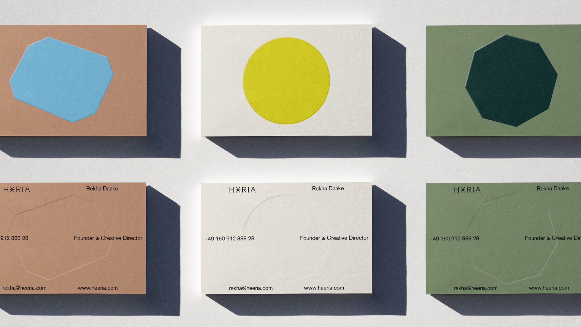 Heeria business cards in all branding colors